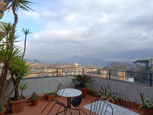 a patio with a table and chairs on a balcony at Casa vacanze Maison Zio Bruno A' Scalinatella in Naples