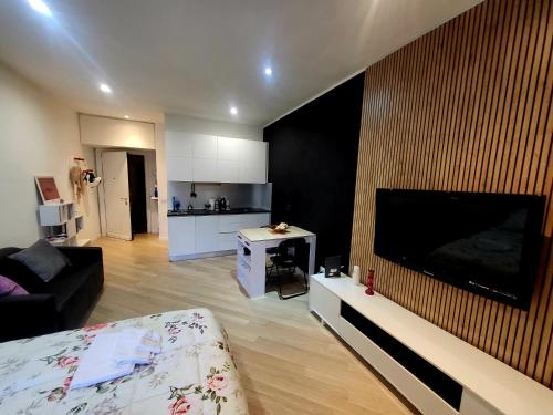 a living room with a large flat screen tv on a wall at Roma Luxury Loft in La Giustiniana