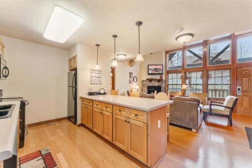 an open kitchen and living room with a couch at Lazy JC Lodge lodge in Branson West