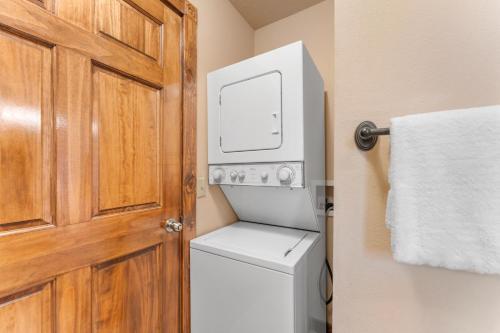a small bathroom with a toilet and a door at Lazy JC Lodge lodge in Branson West