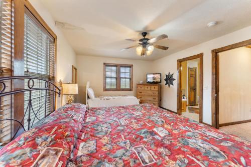 a bedroom with a bed and a ceiling fan at Lazy JC Lodge lodge in Branson West