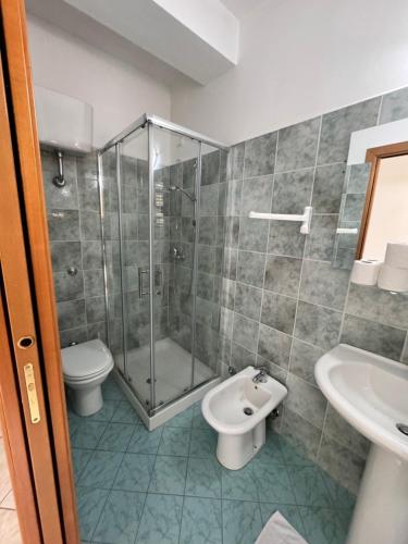 a bathroom with a shower and a toilet and a sink at Da Bosio in Genga