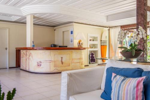a living room with a couch and a table at Le Relais La Borie in Búzios