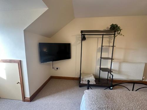 a room with a flat screen tv on the wall at Riverside in Brecon