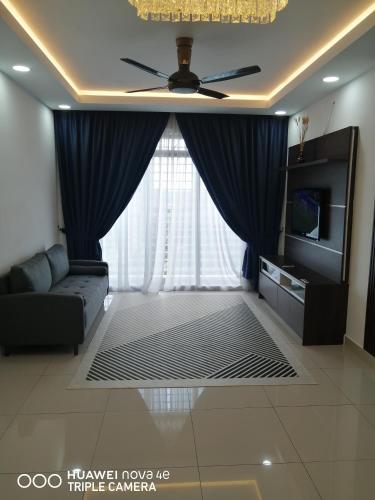 a living room with a couch and a ceiling fan at JANNAH HOMESTAY ii in Putrajaya