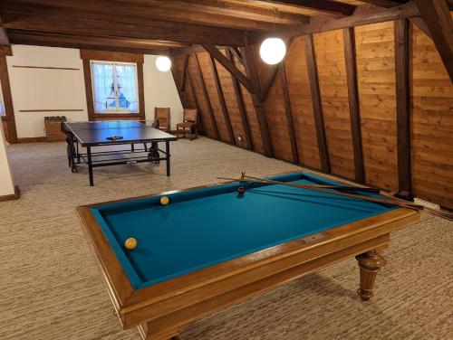 a pool table in a room with a table at Traumschloss für Feste & Feiern in Langrickenbach