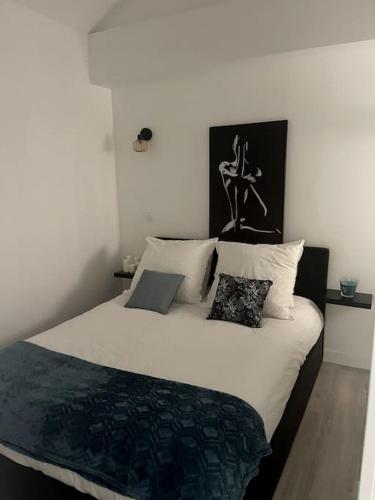 une chambre avec un grand lit avec des oreillers dessus dans l'établissement Eiffel Tour - Cosy Daisy, à Paris