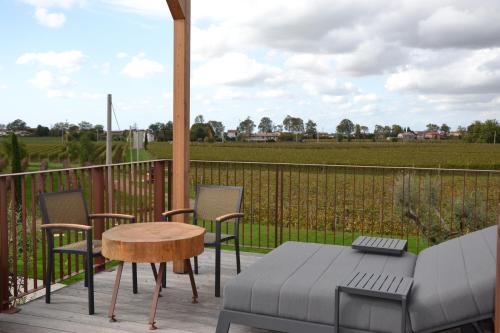 a patio with chairs and a table and a tableablish at Glamping Alvearium Alturis in Gagliano