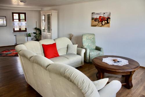 a living room with a couch and two chairs and a table at Ferienhaus zum roten Traktor in Perl
