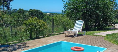 a chair and a frisbee in a swimming pool at Chalé em Torres Recanto Estelar in Torres