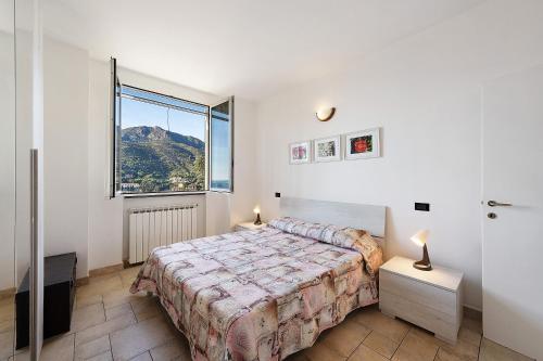 a bedroom with a bed and a large window at Casa Max in Levanto