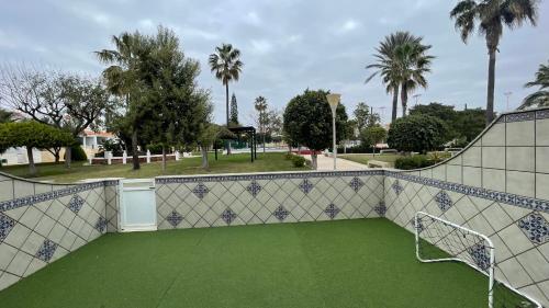 a soccer goal on a soccer field with palm trees at El Paraíso Retamar in Almería