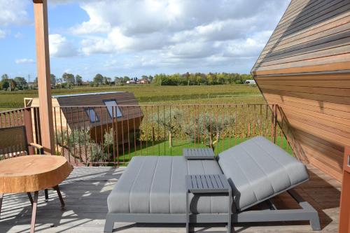 a patio with a bench and a table and a fence at Glamping Alvearium Alturis in Gagliano