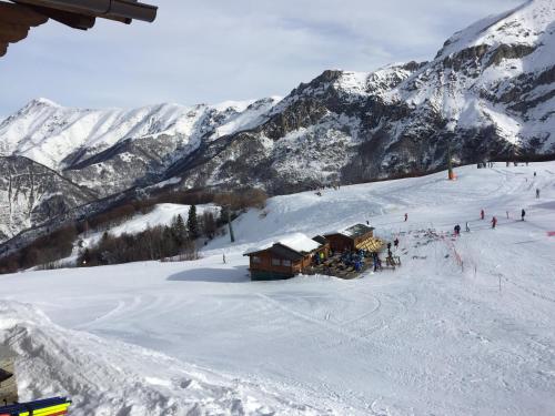 a group of people on a ski slope in the snow at Sulle piste in Limone Piemonte