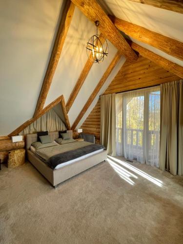 a bedroom with a bed in a wooden ceiling at Zrub Mrázik in Veľká Lomnica