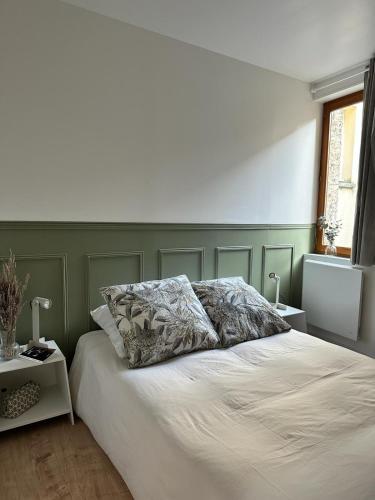 1 dormitorio con cama blanca y pared verde en Appartement T2 hyper centre, en Dieppe