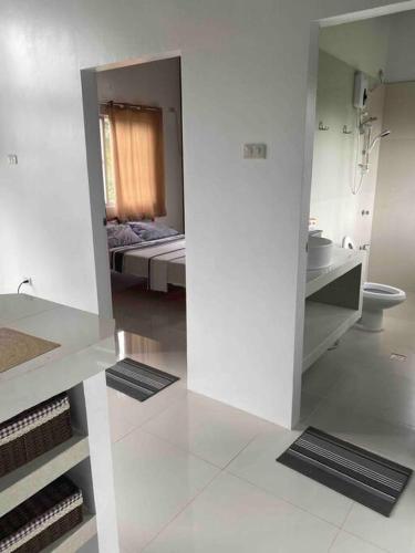 a white bathroom with a bed and a mirror at Casa De Pueblo Japanese Shrine Unit 1 in Valencia