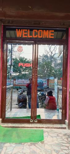 a welcome sign in the window of a store at Mahajan Palace and lodge in Naini