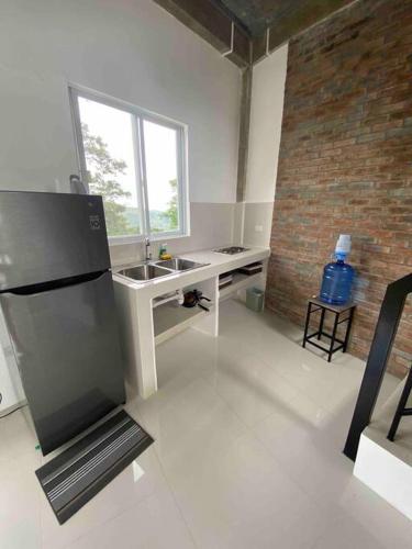 a kitchen with a sink and a desk in a room at Casa De Pueblo Japanese Shrine Unit 1 in Valencia