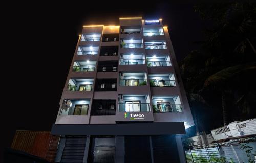 a tall apartment building at night with lights on at Treebo Trend Raana Encore - Near Magarpatta in Pune