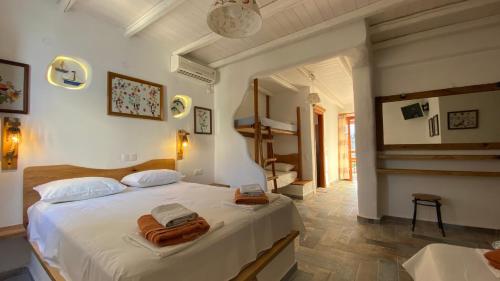 a bedroom with a large white bed with towels on it at Zoe's Place in Ios Chora