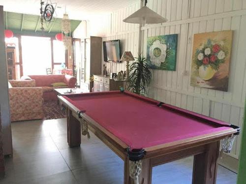 a living room with a pool table in it at Pousada Girassois Hostel in Florianópolis