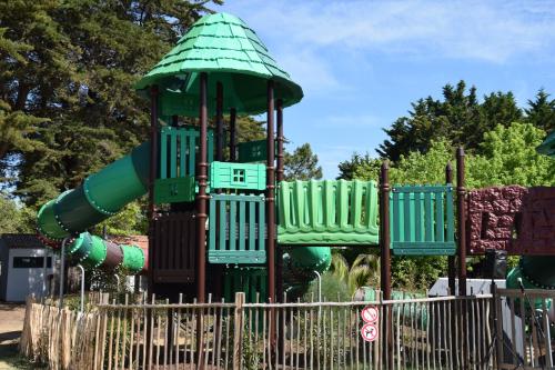 a playground with a slide in a park at Camping Les Maraises in Saint-Martin-de-Ré