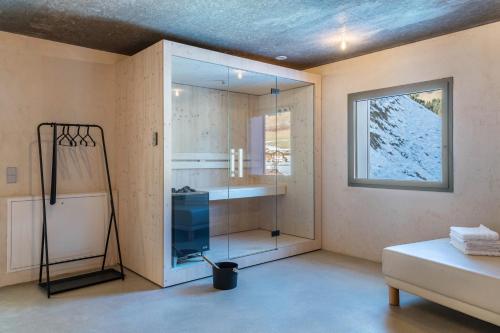 a bathroom with a shower and a glass wall at Lena Dolomites Suite in Villnoss