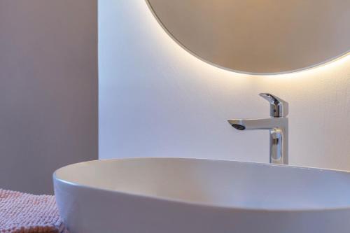 a bathroom with a white sink and a mirror at Lena Dolomites Suite in Villnoss