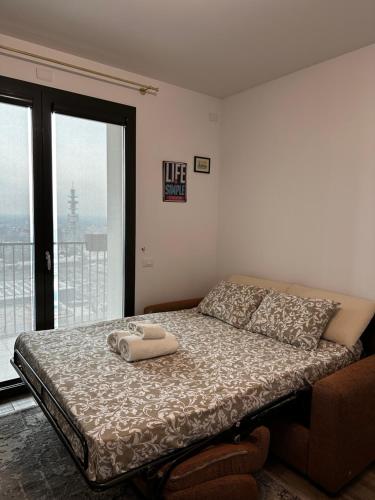 a bedroom with a bed with two towels on it at Sweet Home in Milano smart district in Milan