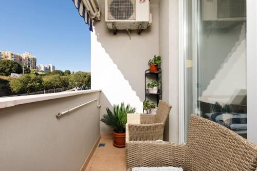 a balcony with two chairs and a window at Apartman Z in Split
