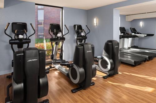 a gym with several treadmills and exercise bikes at Delta Hotels by Marriott Minneapolis Northeast in Minneapolis