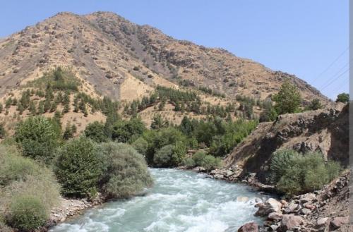 a river with a mountain in the background at Двухуровневая квартира студия - Duplex studio apartment in Dushanbe