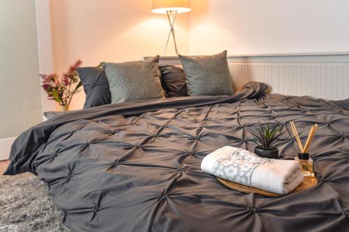 a bedroom with a large bed with a table on it at Central Athena Studio - Inima Pieței Unirii - By OpenHouse apartments in Timişoara