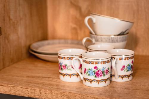 a group of four coffee cups sitting on a table at Central Athena Studio - Inima Pieței Unirii - By OpenHouse apartments in Timişoara