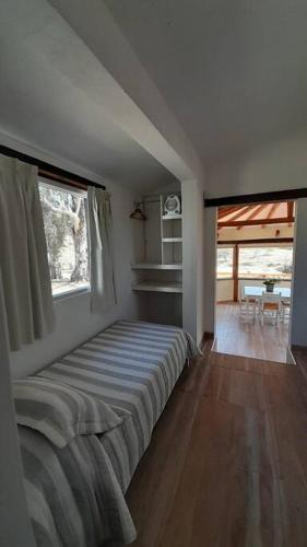 a bedroom with a bed in a room at Cabaña a Arroyo Cristal in Tanti