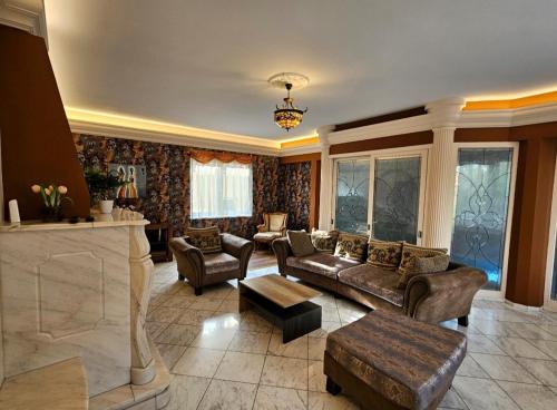 a large living room with couches and a fireplace at Villa Wellness in Budapest