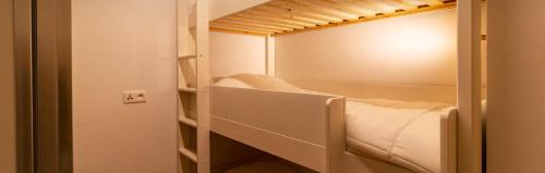 a small room with a bunk bed in it at Appartement de 2 chambres avec piscine partagee et balcon amenage a Les Orres in Les Orres