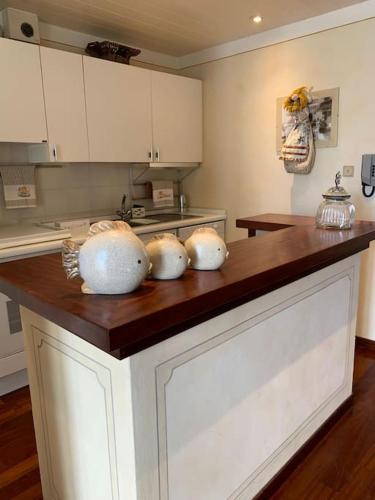 a kitchen with a counter with three bowls on it at Loft Carlotta in Viareggio