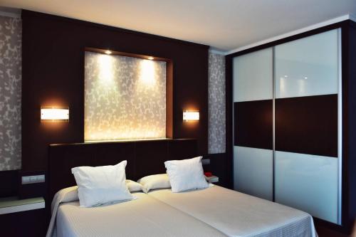 Postel nebo postele na pokoji v ubytování Hotel Alda Carril