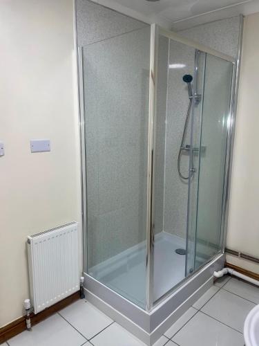 a shower with a glass door in a bathroom at Beautiful 3-Bed Bungalow in Bawtry Doncaster in Doncaster