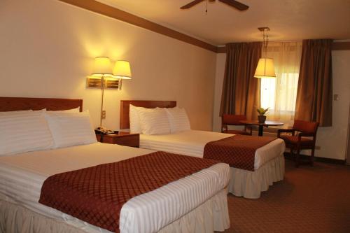 Posteľ alebo postele v izbe v ubytovaní Hotel Santa Fe