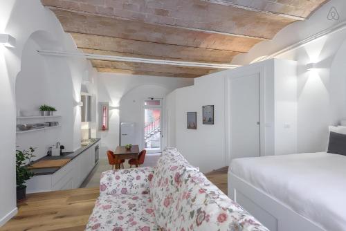 a bedroom with a bed and a living room at FAMM Apartments - Charming open space in Trastevere in Rome