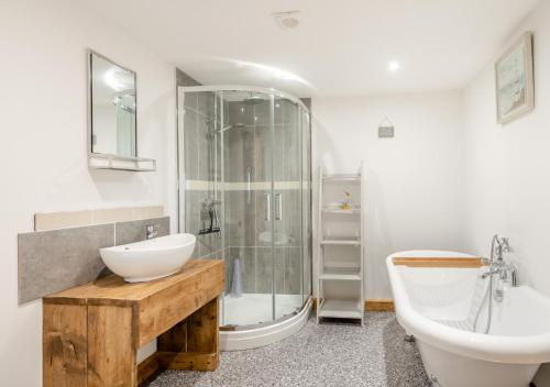 a bathroom with a sink and a shower and a toilet at The Priory in Upwell