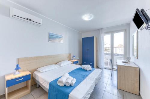 ein Schlafzimmer mit einem Bett mit Handtüchern darauf in der Unterkunft Camere con vista mare a 30 m dal mare in Torre San Giovanni Ugento