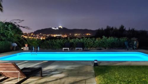 a swimming pool with a view of a city at night at Quinta Verde Sintra - Casa de Campo in Sintra