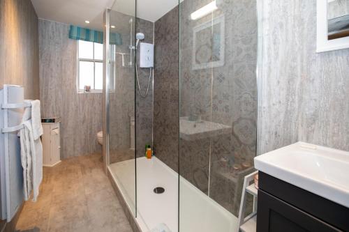 a bathroom with a shower and a sink at Buckthorns House in Leven-Fife