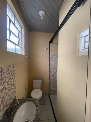 a bathroom with a toilet and a glass shower at Ap completo ótimo local próximo shopping 1 in Campo Grande