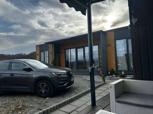 a car parked in front of a house at Stablo guest house in Bărăşti