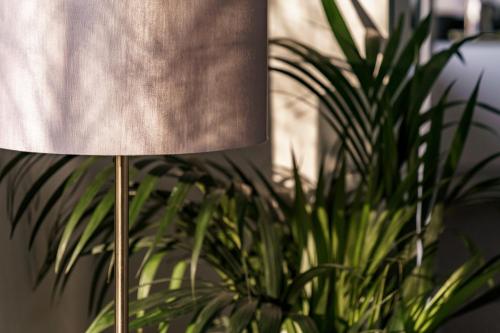a metal lamp sitting next to a plant at Yewbeck: brand new, garden views in Windermere
